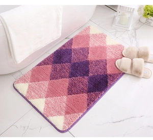 Detailed view of plush purple and pink geometric microfiber bath mat on marble floor