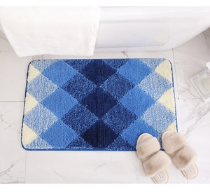 Detailed view of plush gradient rhombus pattern bath mat with absorbent tufted texture