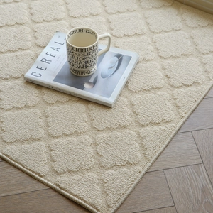 Cream colored indoor mat with textured diamond pattern on wooden floor, home decor