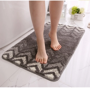 Macro shot of fluffy grey and white geometric wave bathroom mat with soft texture