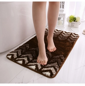 Close-up of soft gradient flocking bath mat with wave texture under bare feet
