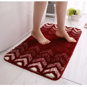 Detailed close-up of thick red microfiber bath mat with wavy pattern and plush texture