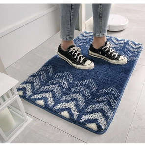 Detail view of blue gradient plush mat with anti-slip texture and soft water-absorbent fibers