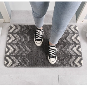 Close-up of geometric flocking rug with anti-slip texture and microfiber plush detail