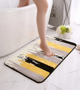 Thick flocked non-slip mat with abstract geometric stripes in yellow and grey