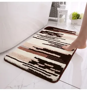 Detailed view of thick microfiber bathroom rug with brown abstract stripes near white bathtub