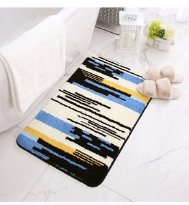 Detailed view of colorful abstract geometric bath mat with soft plush texture and non-slip edge