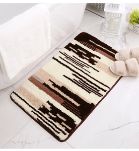 Macro view of thick plush bath mat featuring abstract geometric stripes and non-slip edge