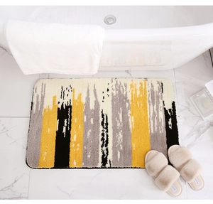 Detail of thickened plush bath mat with abstract stripes on white marble flooring