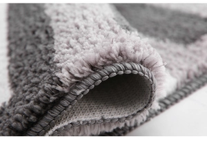 Detailed macro view showing plush shaggy fibers and non-slip backing of the bathroom rug