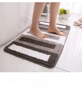 Detailed view of striped absorbent bath mat with soft flocking texture and non-slip edges