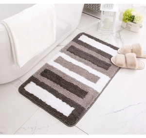 Close-up of grey and white striped bathroom rug showing high-density microfiber texture