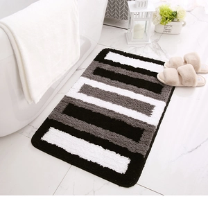 Detailed view of striped rectangular plush bath mat with thick absorbent tufted texture