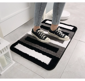 Close-up of minimalist tricolor striped flocking bath mat with soft non-slip texture