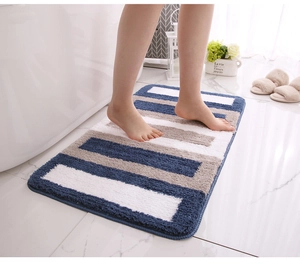 Detailed plush texture of a non-slip bathroom mat with blue and grey stripes