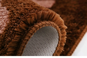 Close-up of plush shaggy carpet with non-slip backing and fine edge stitching detail