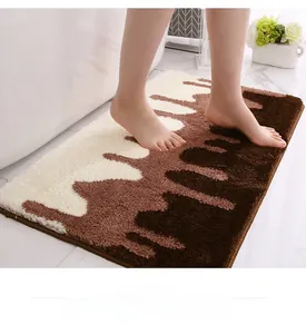 Detailed shot of soft anti-slip bath mat with brown flowing pattern under feet