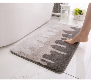 Detailed close-up of thick non-slip bathroom rug with plush texture and wave pattern