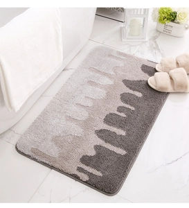 Detail of soft thick absorbent bathroom rug with grey gradient wave pattern in modern decor