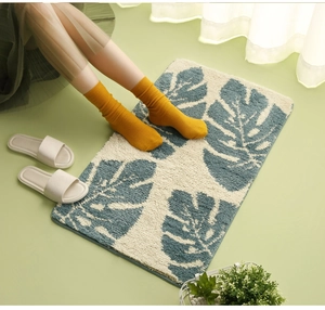 Close-up of soft monstera leaf patterned door mat with thick microfiber texture