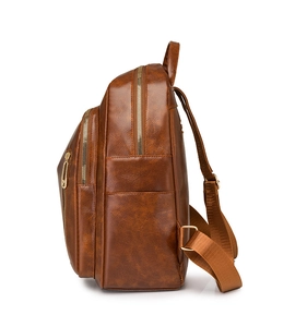 Detailed side view of brown PU leather backpack with multi-zipper layers and side pocket