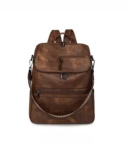 Detailed front view of brown vintage backpack featuring colorful woven straps and hardware