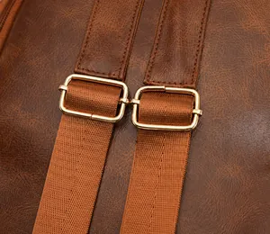 Detail of adjustable buckle and brown faux leather strap on large capacity shoulder bag