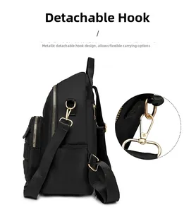 Detail of waterproof Oxford backpack showing shiny gold hardware and removable metal hooks