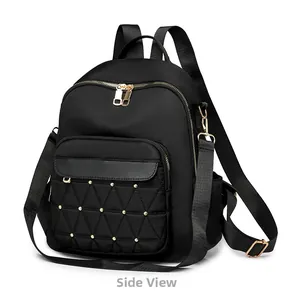 Detail view of black oxford backpack showing diamond quilting and gold stud accents