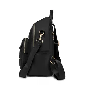 Side view of black Oxford fabric backpack with gold zippers and quilted front pocket detail