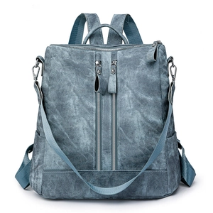 Minimalist textured denim blue backpack with double vertical zippers and versatile straps