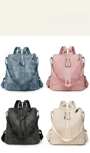 Detail view of multi-color PU leather backpacks in blue, pink, black, and beige textures