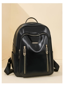 Detail of high-quality black PU leather backpack featuring multi-zipper and gold hardware