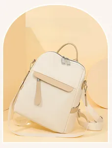 Detail of off-white and brown Oxford cloth backpack with premium metal zippers