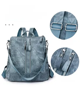Detail of vintage blue backpack with silver metal buckle and double zipper accents