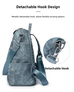 Detail of the detachable metal hook and adjustable strap on a grey backpack