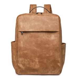 Front view of vintage caramel brown PU leather backpack with dual zippers and front pocket