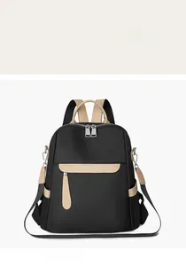 Close-up of contrast beige leather handle and black water-resistant oxford fabric