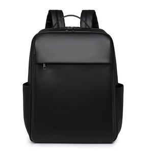 Front view of matte black minimalist backpack featuring adjustable straps and top handle