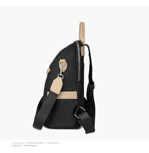 Detailed side view of black Oxford backpack with beige leather accents and silver zippers
