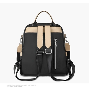 Detail of waterproof nylon backpack featuring a vertical anti-theft back pocket and straps