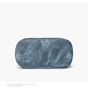 Detailed view of the vintage washed blue-grey canvas fabric and textured material