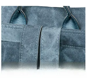 Detail of reinforced stitching and durable twill fabric on dark blue laptop backpack