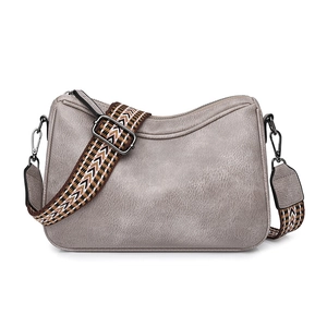 Detail of grey textured shoulder bag with a wide geometric pattern woven strap
