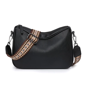 Black pebble leather saddle bag with wide colorful geometric pattern woven strap