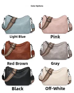 Detailed view of semi-circle crossbody bags with wide ethnic jacquard shoulder straps