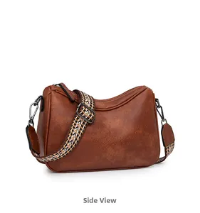 Side view of retro brown crossbody bag with textured leather and woven strap