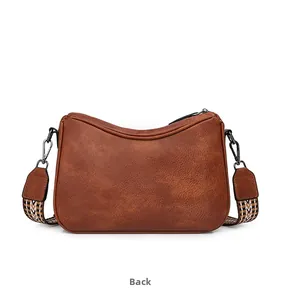 Rear view of brown retro shoulder bag showing lychee pattern leather and woven strap