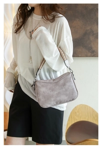 Silver-grey vintage shoulder bag with textured leather and woven geometric strap details
