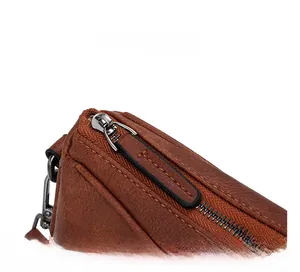 Detailed macro view of the smooth brown leather bag featuring a durable metal zipper closure